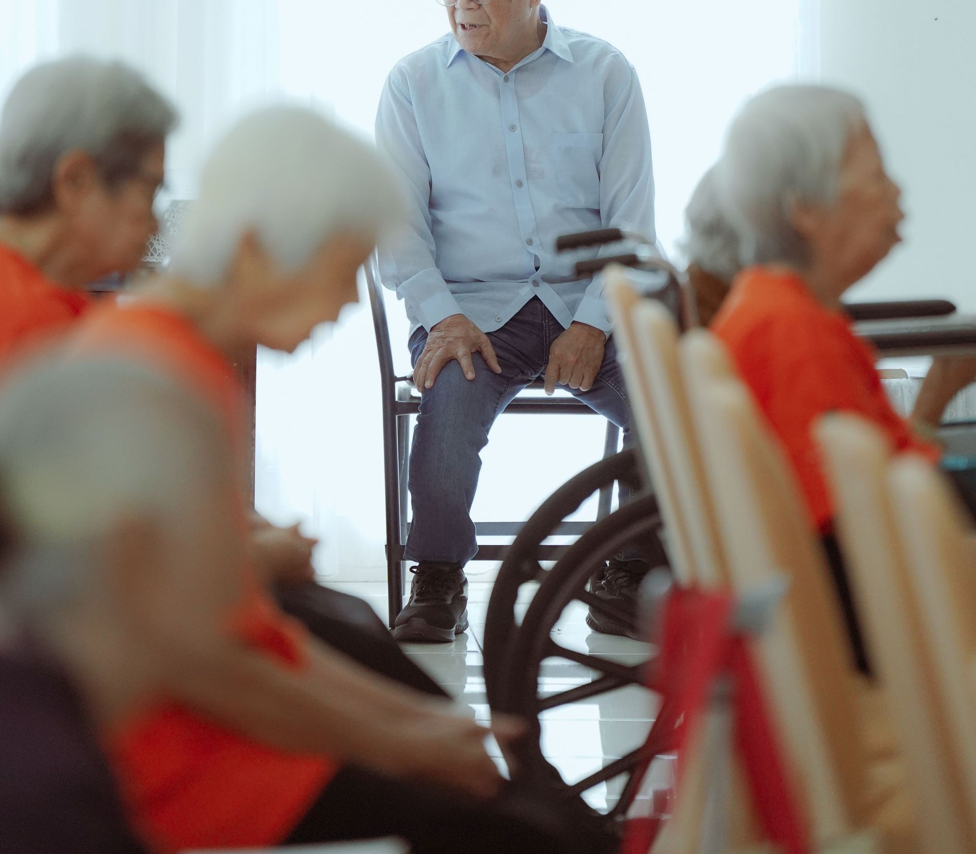 Elderly individuals in a Jakarta meeting room, promoting community and socialization.