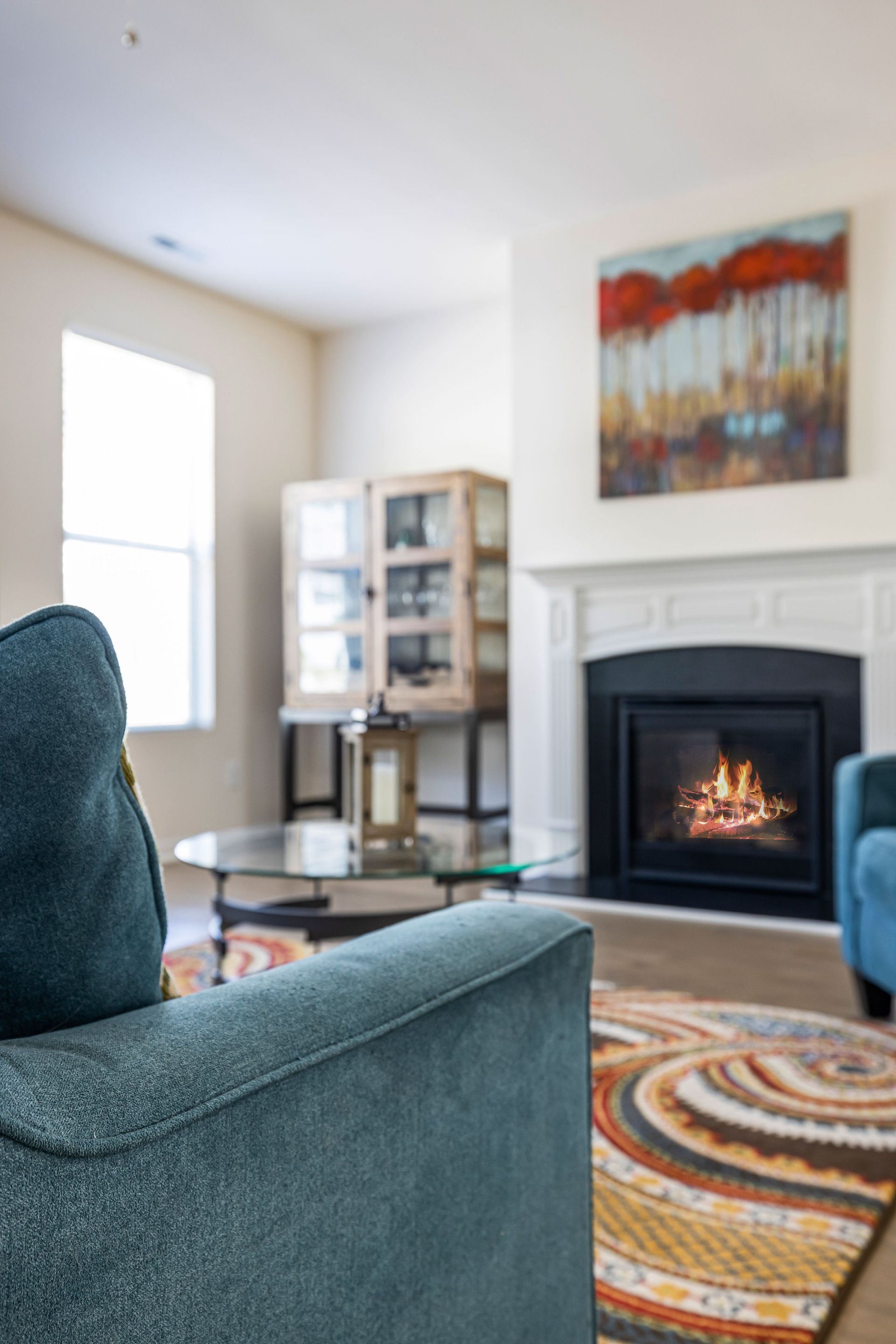 Modern living room with cozy fireplace, stylish furniture, and elegant decor.